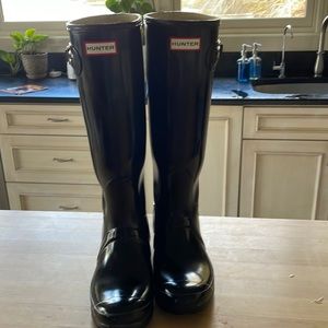 Glossy black Hunter rain boots, sock liners and boot shine